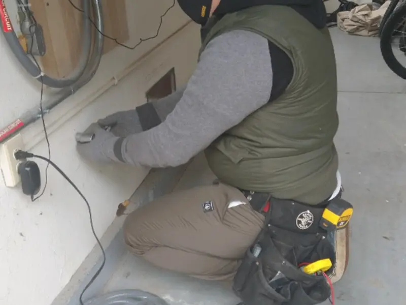 Electrician performing outlet wiring in a Ashland City garage